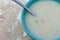 Chowder in a green bowl with a spoon in the food top view