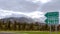 Chrea snowy mountain in Blida and directional road sign.