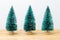 Chrismas trees with white background on wooden table