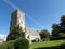 Christchurch church with bright blue sky and airplane trail