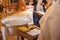 Christening ceremony in the Orthodox church, priest lighting candles at children baptismal font, close up