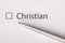 Christian - checkbox with a tick on white paper with metal pen. Checklist concept