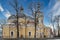 Christian church with a bell tower and a clock tower against a blue sky