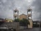 Christian Church with a bell tower in the Greek village of Agios Afanasios in Evia and in the summer a thunderstorm with black clo