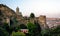 Christian church on the mountain and the old antique fortress against the backdrop of the cityscape