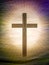 Christian cross on abstract landscape background with rays of glory. Religious Easter.