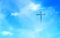 Christian cross appeared bright in the sky with soft fluffy clouds The Christian cross looks bright in the golden sky, with soft w