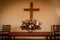 Christian cross and flowers on altar