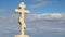 Christian cross on grave stone, peaceful blue sky background, religion, church