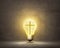 Christian cross inside bright bulb