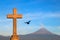 Christian cross and raven on the background of the active volcano Popokatepetl. Catholic Church of St. Mary. Mexico. Cholula city.