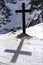 Christian cross in the winter mountains. Death in the mountains