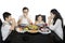 Christian family praying before having lunch