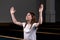 A Christian girl in white shirt is sits with his hands up and face and praying with humble heart in the church