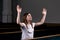 A Christian girl in white shirt is sits with his hands up and face and praying with humble heart in the church