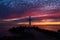 Christian Holy cross early in the morning at sunrise. The large cross stands on the edge of a breakwater on the sea