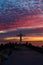 Christian Holy cross early in the morning at sunrise. The large cross stands on the edge of a breakwater on the sea