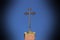 Christian metal cross on top of a clinker church