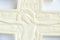 Christian plaster cross on a white background close-up, love of god