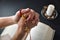 Christian praying with rosary in his hands with interlocked fingers