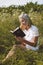 Christian teenage girl reading the Bible in the field. Faith, spirituality and religion concept