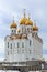 Christian temple. Beautiful large white building with golden domes and crosses