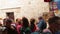 Christian tourists people visiting in the Jesus hand print in Via Dolorosa station 5 in the old city of Jerusalem