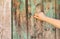 Christian woman`s hand knocking on an old wooden door. Seek and find God and Jesus Christ.