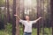 Christian worship with raised hand in pine forest,Happy woman de