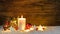 Christmas or Advent candle with red and white christmas ornaments and festive light