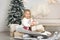 Christmas is already here. Girl sledding with christmas gift box. Small cute girl received holiday gifts. Kid hold gift box while