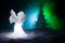 Christmas Angel glass xmas figure and glass fir tree, christmas tree, docorative elements on dark background. Christmas decoration