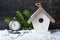 Christmas antique clock and a birdhouse on a wooden background