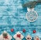 Christmas azure background with handmade gifts and a fir tree toy on his right. Space for text