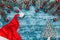 Christmas azure background, Santa`s work table, fir branches adorned with red globes. Top view