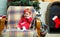 Christmas baby. Beautiful baby goll girl in red christmas costume smile and seat at chair. Christmas eve. Holiday. Xmas