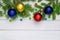 Christmas back ground  green fir branches  red and blue  yellow  ball  white boards