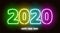Christmas background. 2020. Isolated. Neon multicolored sign. Against a brick wall.