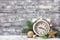 Christmas background with alarm clock, branches of fir tree and