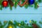 Christmas background, blue boards green branches color balls, candy