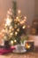 Christmas background with blurred details. Christmas tree with garlands at home. Photo from bokeh. Free space for text