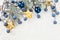 Christmas background border with corner composition made of green Xmas fir branch, blue berries and gold New Year decoration