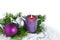 Christmas background with candle and decorations. Purple and silver Christmas balls over fir tree branches