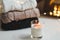 Christmas background. Candle, knitted sweater, christmas decorations and bokeh lights background. Christmas cozy mood still life