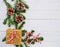 Christmas background with candy cane, gift, cones and fir branches over white wooden table