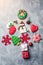 Christmas background with colorful gingerbreads. Christmas presents, decorations, gingerbread on grey concrete background. Flat