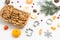 Christmas background with cookies in basket, tangerines, fir branches, cookies molds and cranberries