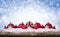 Christmas Background - Decorated Red Balls On Snow with snowflakesand stars on wooden desk