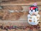 Christmas background decorations with Snowman and gift boxes on the old wood board by Flat lay, top view and copy space