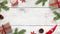 Christmas background with decorations on white wooden surface. Copy space in the middle
